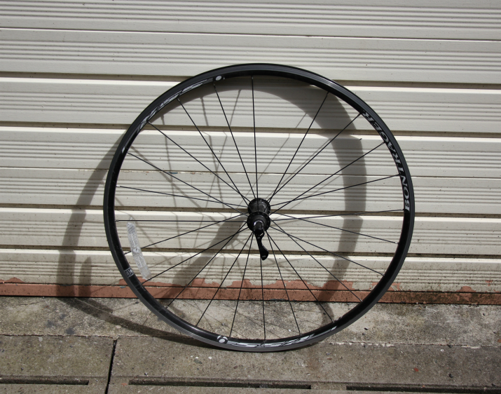 Bike wheel in front of garage Bike wheel in front of garage