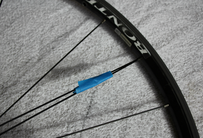 Broken spoke taped to another spoke Broken spoke taped to another spoke
